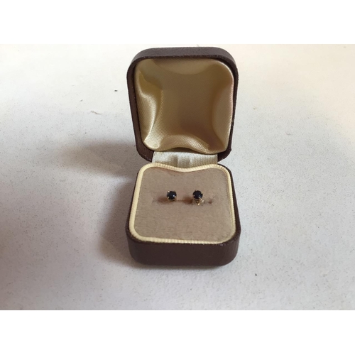 58 - A pair of gold mounted sapphire stud earrings - hall mark to shank. Sapphire approx 3mm