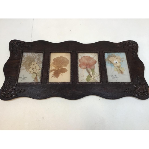 33 - Victorian cards in carved oak frame depicting flowersW:49cm x H:23cm
