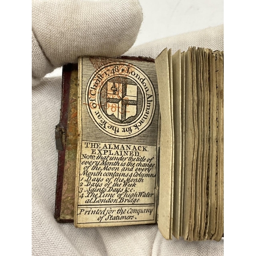 737 - 1748 miniature bound almanac with concertina illustration of Christ’s Hospital, London. Small clasp ... 