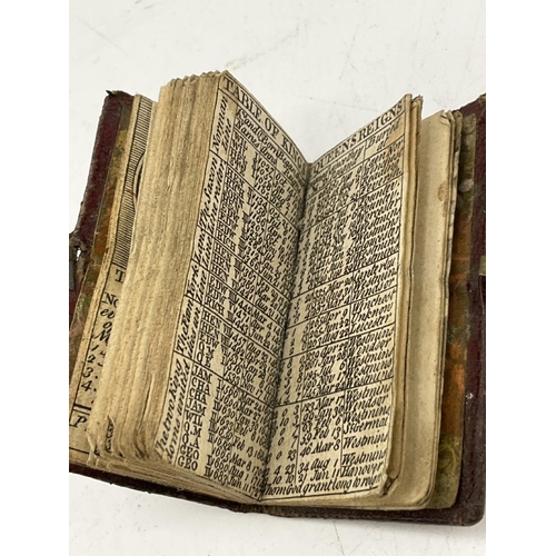 737 - 1748 miniature bound almanac with concertina illustration of Christ’s Hospital, London. Small clasp ... 