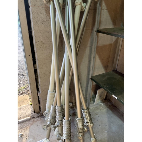 Nine curtain poles and fittings for tie backs.