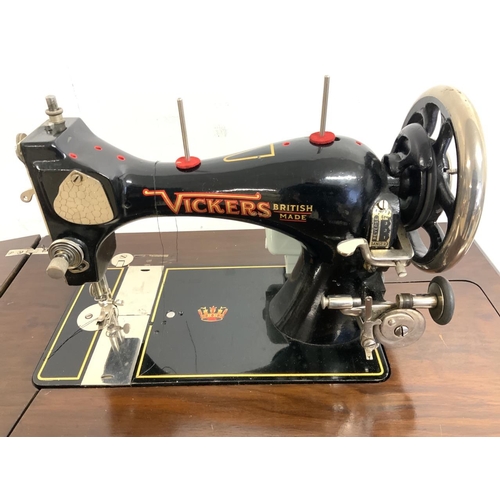 A Vickers sewing machine in fitted table, with three frameless mirrors
