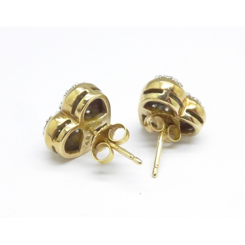 1064 - A pair of 9ct gold and diamond earrings, 4.5g