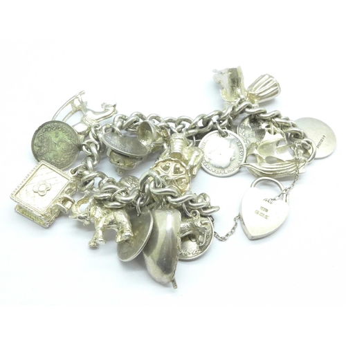 1070 - A silver charm bracelet, 87g