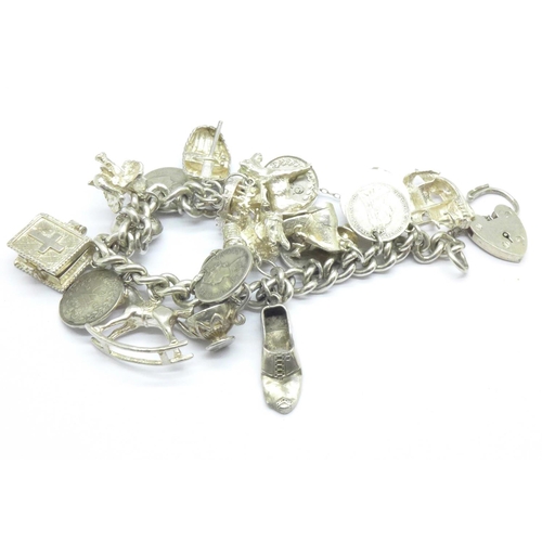 1070 - A silver charm bracelet, 87g