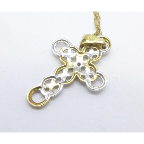 1071 - A 9ct gold and diamond cross pendant on a 9ct gold chain, 2g