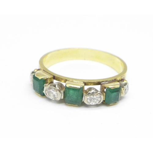 1079 - An 18ct gold, diamond and emerald seven stone ring, 3.2g, J