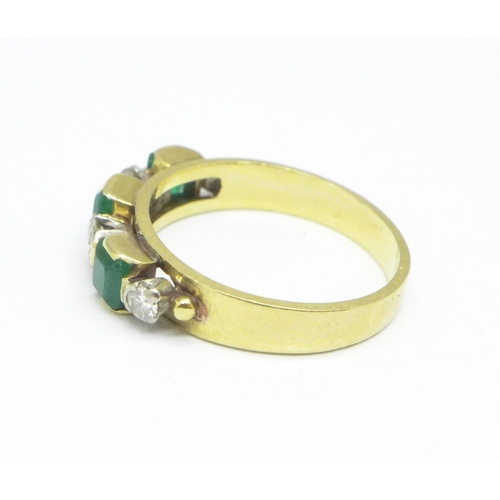 1079 - An 18ct gold, diamond and emerald seven stone ring, 3.2g, J