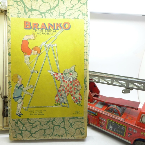 660 - A tin plate toy fire engine and a Branko Japanese mechanical acrobat, boxed