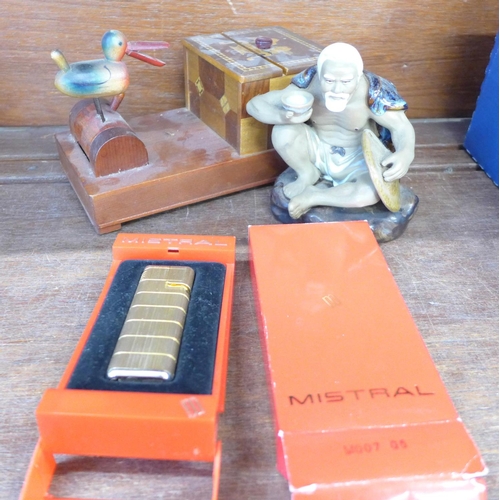 673 - A novelty cigarette box/dispenser, a Mistral lighter and a Chinese figural insense burner