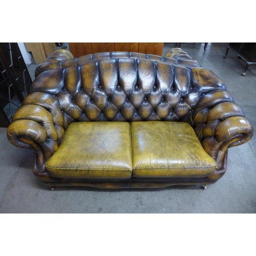 106 - A Chesterfield brown leather settee