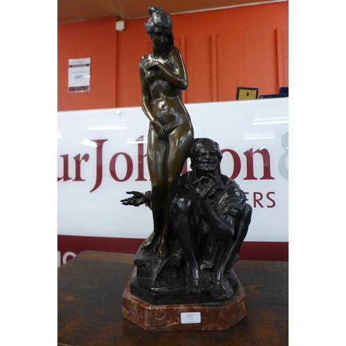 113 - A large French style bronze figure of a female nude and Arabic man, on red marble plinth