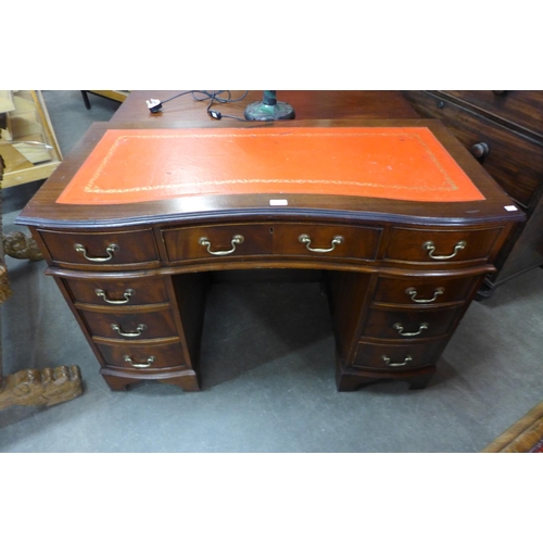 118 - A mahogany serpentine desk