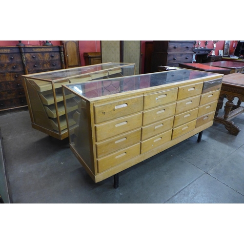 121 - A pair of mid 20th Century oak haberdashery shop cabinets