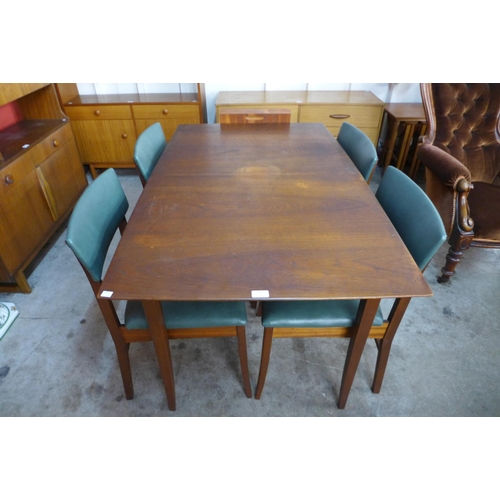 126 - A teak extending dining table and four chairs