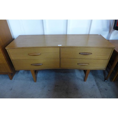 127 - A small teak concave sideboard