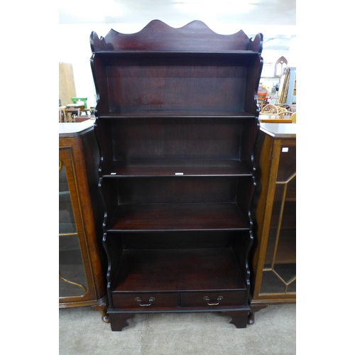 160 - A mahogany open waterfall front bookcase