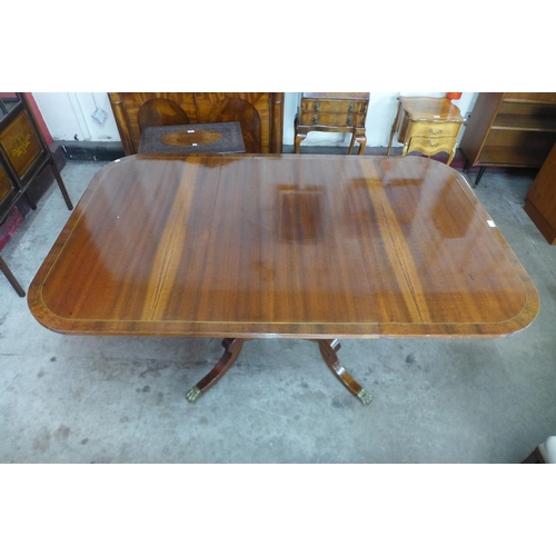 195 - A Regency style inlaid mahogany extending pedestal table