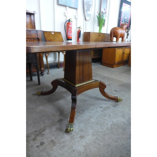 195 - A Regency style inlaid mahogany extending pedestal table