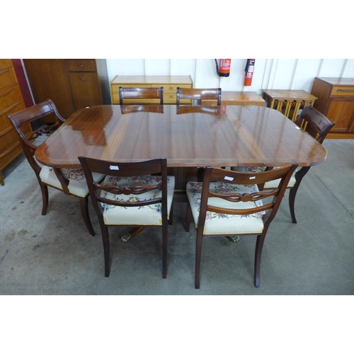 195 - A Regency style inlaid mahogany extending pedestal table