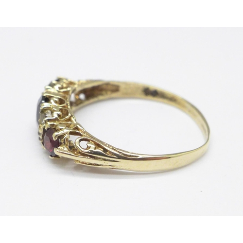 1017 - A 9ct gold, garnet and white stone ring, 2.4g, T