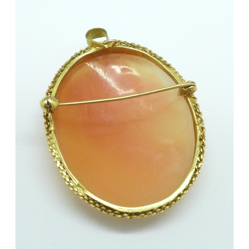 1034 - A 14ct gold mounted cameo brooch, the loop marked k14