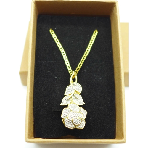 1038 - A silver gilt pendant with diamond accent