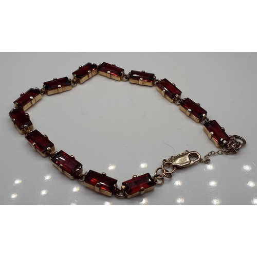 1053 - A 9ct gold and fire garnet bracelet, 12.2g