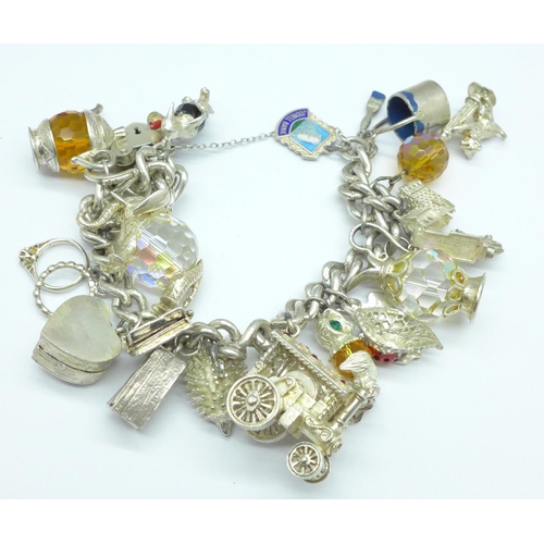 1070 - A silver charm bracelet, 122g