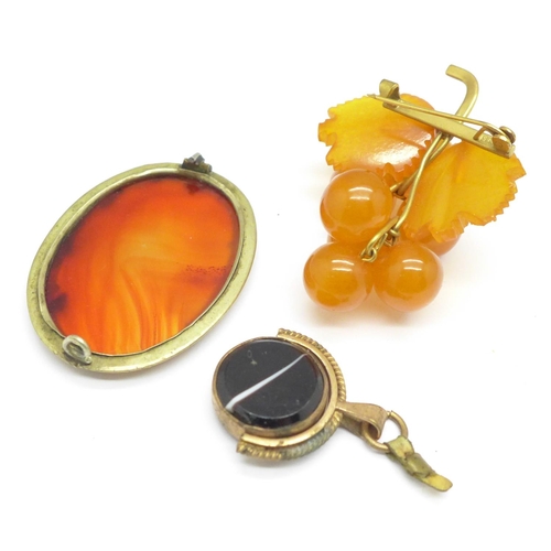 1081 - An amber brooch, a fob, etc.