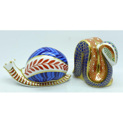 632 - Two Royal Crown Derby paperweights, Snake and Snail, Snake with gold stopper