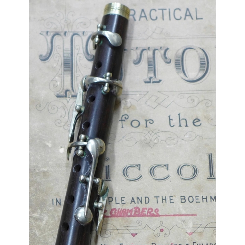 699 - A cased Piccolo and a Practical Tutor instruction book