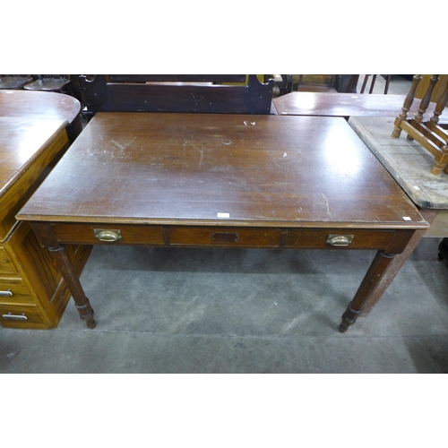 221 - An early 20th Century mahogany writing table (lacking drawers to one side)