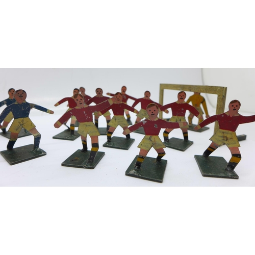 816 - Two early 20th Century 'tiddly-wink' tin plate football teams with articulated goalkeepers and two g... 