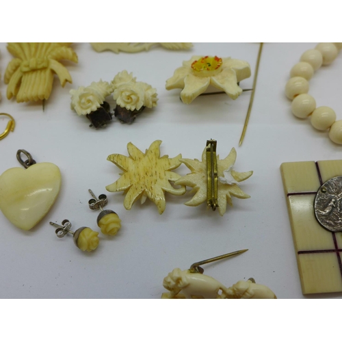 837 - A collection of bone and ivory brooches, earrings, pendants, necklace and stick pin