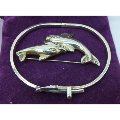 846 - Three silver bracelets, including a heavy articulated fish bracelet, (71g), a silver bangle, a silve... 