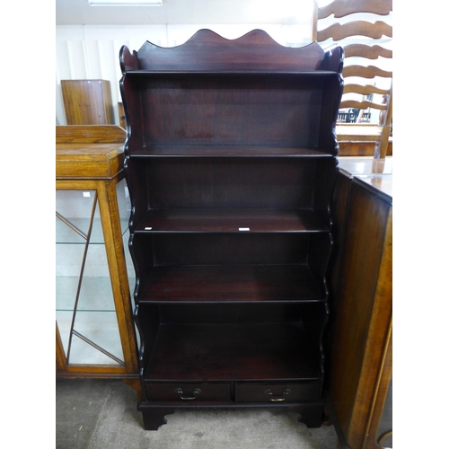 160 - A mahogany open waterfall front bookcase