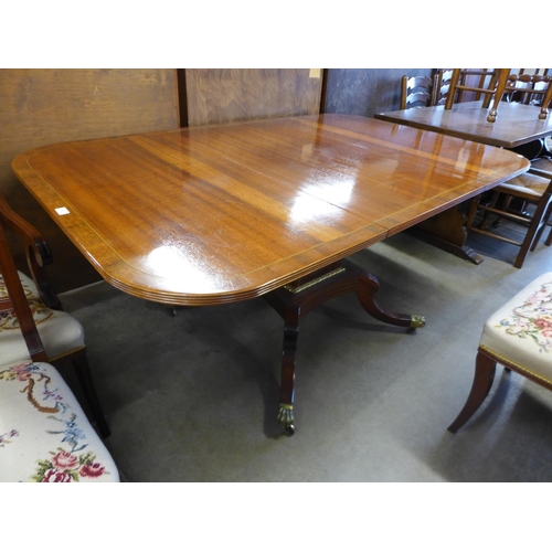 195 - A Regency style inlaid mahogany extending pedestal table