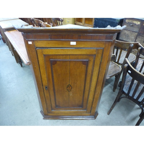 210 - A George III oak hanging corner cupboard