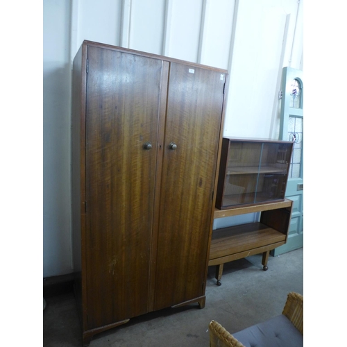 267 - A Lloyd Loom chair and four cane chairs and a teak wall mounted unit, a serving trolley and a wardro... 