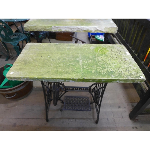 297 - A cast iron based and reconstituted stone topped table