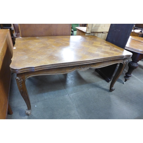 95 - A French oak parquetry top draw-leaf dining table