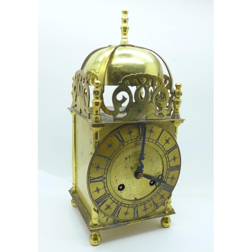 673 - A brass lantern clock with Shatz of Germany movement