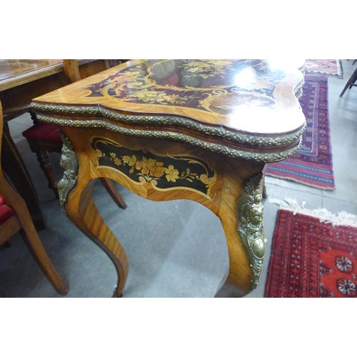 101 - A 19th Century rosewood, marquetry inlaid and ormolu mounted fold-over card table