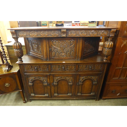 109 - A 17th Century style carved oak court cupboard