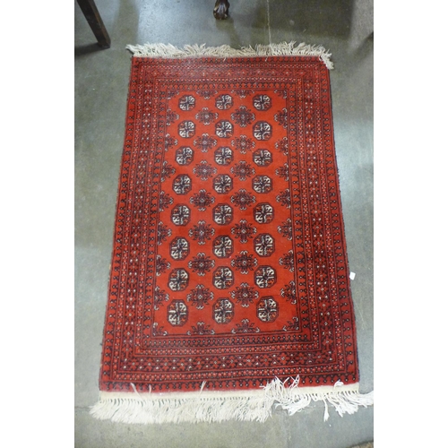 115a - A small red ground rug