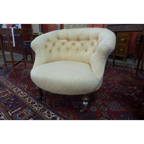 87 - A Victorian walnut and upholstered lady's tub chair
