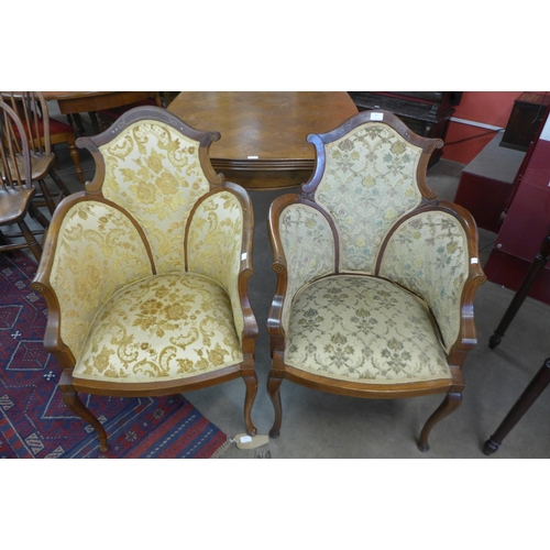 94 - A pair of Edward VII inlaid mahogany and upholstered tub chairs