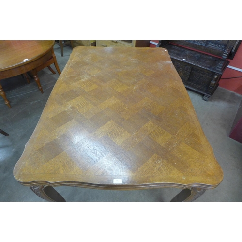 95 - A French oak parquetry top draw-leaf dining table