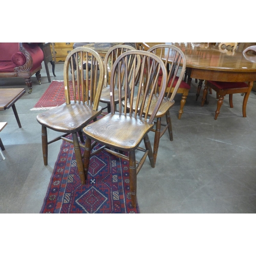 96 - A set of four elm and beech Windsor kitchen chairs, stamped Aple & Co., 1915